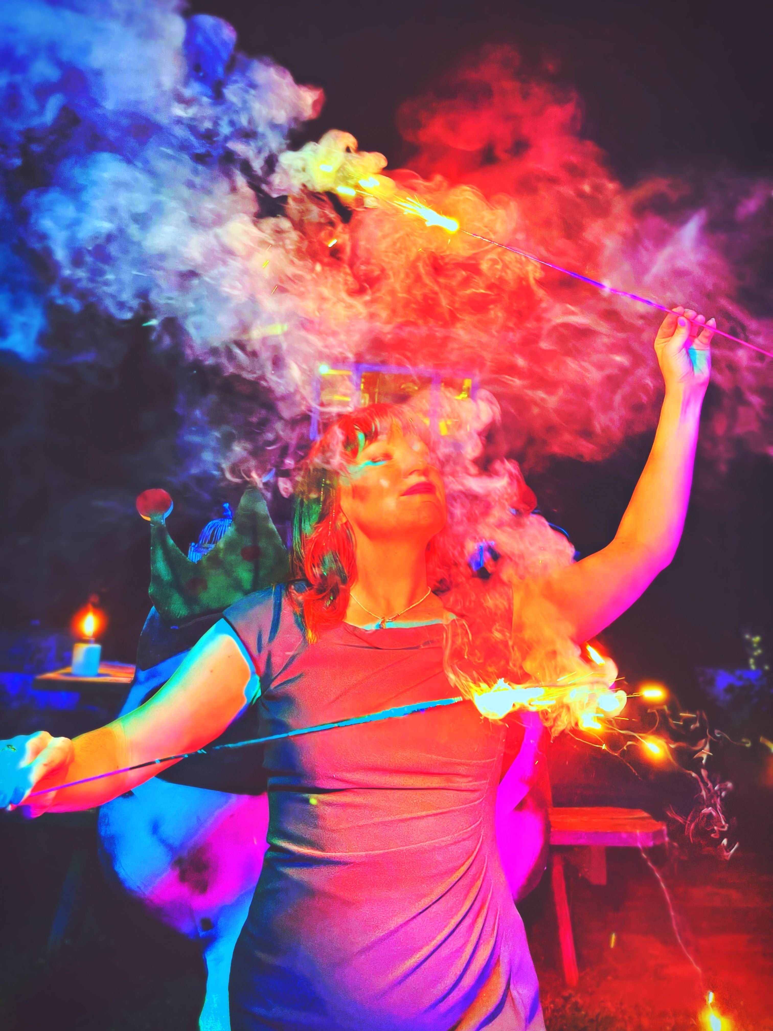 Photo of a woman dancing with fire swirling around her