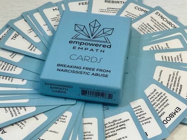 The first card deck created by a survivor to support breaking free from narcissistic abuse with evidence-based guidance, compassion, and practical tools.

Breaking free from narcissistic abuse is incredibly difficult - and there are few tools designed to actually help.

The Empowered Empath Card Deck fills that gap. Created by a survivor of narcissistic abuse, this deck distills months of coaching work and hard-won wisdom into a portable, accessible tool that meets people exactly where they are.

What makes it different:
These aren't typical oracle cards. Each card features practical guidance, encouragement, and inspiration specifically designed to:

*Help you recognize abuse patterns and break trauma bonds
*Rebuild the self-trust and intuition that abuse erodes
*Calm your nervous system during overwhelm
*Cut through confusion and cognitive dissonance
*Provide accessible support anywhere, anytime

Why it matters:
Empaths often struggle the most in narcissistic relationships. They absorb others' emotions, second-guess their own experiences, and blame themselves for the abuse. This deck speaks directly to that experience - created with the wisdom and compassion of someone who has lived it.

The creative process:
Months of distilling coaching content into card wisdom, designing cards that feel beautiful but purposeful, and creating a tool that doesn't shame or judge - just supports and guides.

How it's used:
Like a wise friend in a box. Draw a card when you're confused, struggling, or ready to take the next step. Use during therapy, while journaling, in your car, at work - anywhere you need clarity and encouragement.

The Empowered Empath Card Deck is now available on The Healing Collective, with free resources also available to support your healing journey.