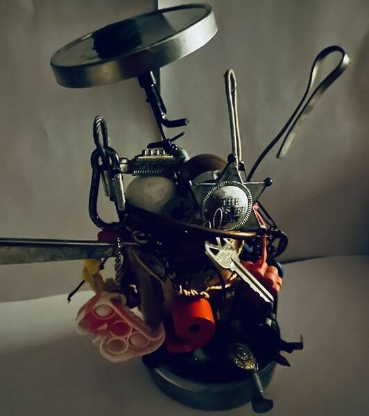 I walk. And when I walk, I collect items. Sometimes it's junk. Sometimes it's waste. Sometimes it's hardware. Sometimes it's treasure. (I find a lot of change.) 

It ends up in a box. And that's where it sits. 

Inspired by an overnight stay at Howard Finster's Paradise Garden a few years back, my Release Day goal was to create something new: A found object assemblage that tells the story of my life. 

This is a medidation
