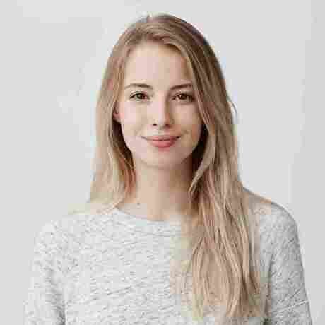 Pretty smiling joyfully female with fair hair dressed casually looking with satisfaction 11zon 11zon