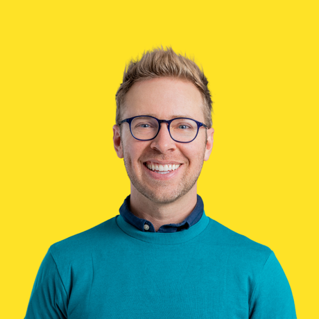 Nick gray headshot yellowbackground