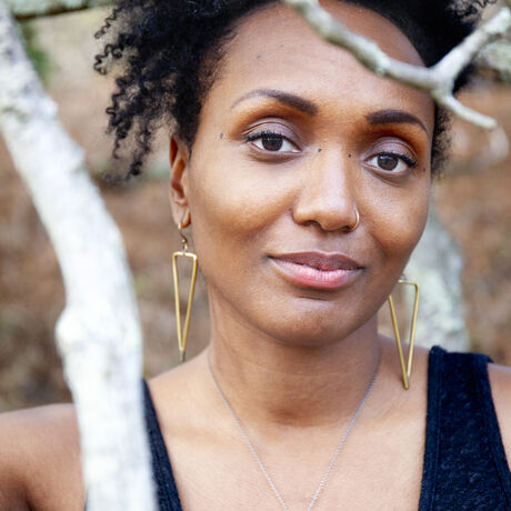 Rebecca kellyg behind tree