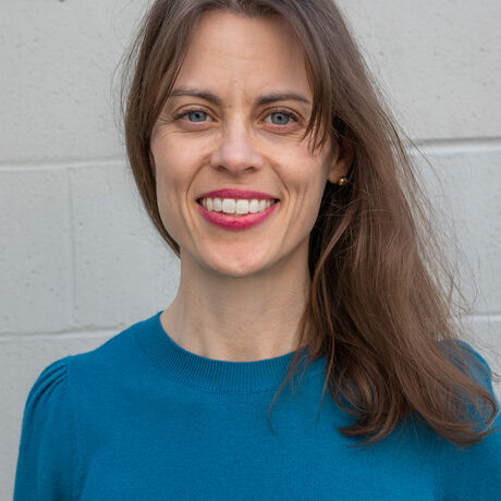 Melissa headshot white brick wall